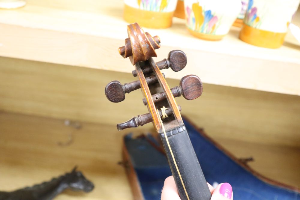 A cased violin, labelled Buthod, Paris, length of back 36cm, with bow stamped Tourte